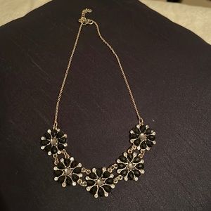 Gold necklace with black flowers